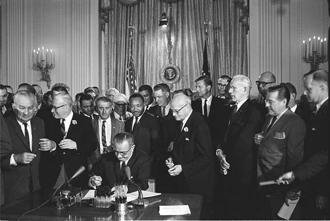 President Lyndon Johnson signs the Civil Rights Bill of 1964